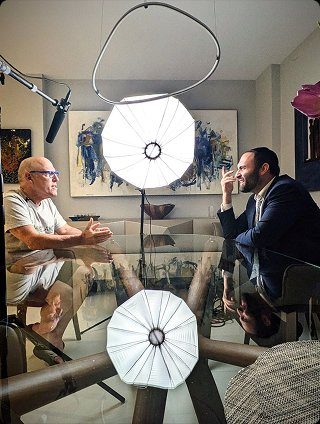 Laibel listening during an interview on set